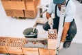 Professional construction worker building walls and bricklaying rows of bricks Royalty Free Stock Photo