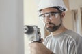 Professional construction worker using a drill