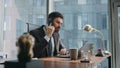 Professional consultant talking phone at office table looking laptop close up. Royalty Free Stock Photo