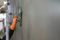 Professional contractor plastering wall with sponge float to make a smooth rendering Royalty Free Stock Photo