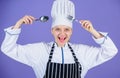 Professional cook of culinary school. Culinary arts academy. Woman professional chef hold utensil spoon fork having fun Royalty Free Stock Photo