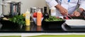 Professional cook cutting ingredients and preparing a white plate for a delicious meal Royalty Free Stock Photo