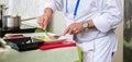Professional cook, dressed in white and preparing a well balanced healthy meal Royalty Free Stock Photo