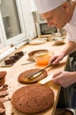 Professional cook spreading jam on cake Royalty Free Stock Photo