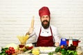 Professional cookery concept. Man with beard holds rolling pin