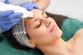 Professional cosmetologist is undergoing cavitation facial treatment