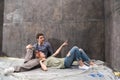 Professional couple sitting together on floor and discussing renovation home