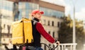 Professional Courier With Backpack Riding Bike Delivering Food In City