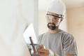 Professional craftsman applying plaster with a trowel