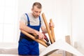 Professional Craftsman Carpenter Installing Table Using Electric Drill Indoors