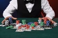 Professional croupier accepting bets at gambling table, closeup Royalty Free Stock Photo