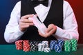 Professional croupier shuffling cards at gambling table, closeup Royalty Free Stock Photo