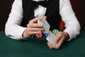 Professional croupier shuffling cards at gambling table, closeup Royalty Free Stock Photo