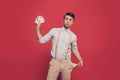 Professional, cunning magician, illusionist, gambler in casual outfit, holding, showing set of cards and empty pocket out, standin