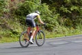 A professional cyclist mountain biker wearing cycling tights and helmet is riding bike on Skyline drive,