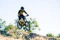 Cyclist Riding the Mountain Bike on the Summer Rocky Trail at the Evening. Extreme Sport and Enduro Cycling Concept. Royalty Free Stock Photo