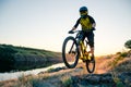 Cyclist Riding the Mountain Bike on the Summer Rocky Trail at the Evening. Extreme Sport and Enduro Cycling Concept. Royalty Free Stock Photo