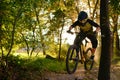 Professional Cyclist Riding the Mountain Bike on the Autumn Forest Trail. Extreme Sport and Enduro Cycling Concept. Royalty Free Stock Photo