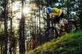 Professional Cyclist in Yellow T-shirt and Helmet Riding the Bike Down Hill in Forest. Extreme Sport Concept. Royalty Free Stock Photo