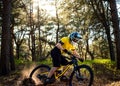 Professional Cyclist in Yellow T-shirt and Helmet Riding the Bike in Forest. Extreme Sport Concept. Royalty Free Stock Photo