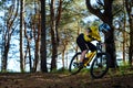 Professional Cyclist in Yellow T-shirt and Helmet Riding the Bike in Forest. Extreme Sport Concept. Royalty Free Stock Photo