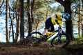 Professional Cyclist in Yellow T-shirt and Helmet Riding the Bike in Forest. Extreme Sport Concept. Royalty Free Stock Photo