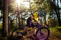 Professional Cyclist in Yellow T-shirt and Helmet Riding the Bike in Forest. Extreme Sport Concept. Royalty Free Stock Photo