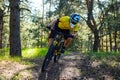 Professional Cyclist in Yellow T-shirt and Helmet Riding the Bike in Forest. Extreme Sport Concept. Royalty Free Stock Photo