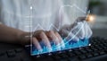 Professional data analyst working on financial graphs and statistics with modern technology on a keyboard, showcasing Royalty Free Stock Photo