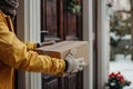 Professional delivery service. hands placing package near the door for efficient and timely arrival