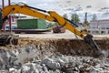 Professional demolition of reinforced concrete structures using industrial hydraulic hammer with excavator. Rods of metal fittings