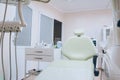 Professional dental unit with green chair and tools. Dentistry, medicine, medical equipment and stomatology concept. White tone Royalty Free Stock Photo