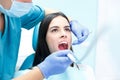 Dentist curing a female patient in the stomatology. Treatment concept. Royalty Free Stock Photo