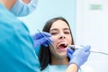 Dentist curing a female patient in the stomatology. Treatment concept. Royalty Free Stock Photo