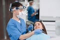 Professional dentist examination patient with microscope at the office