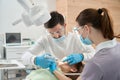 Professional dentist injecting anesthetic to patient gum before procedure