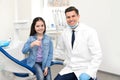 Professional dentist and little girl