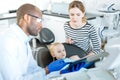 Professional dentist showing dental X-ray to his little patient Royalty Free Stock Photo