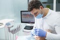 Professional dentist treating teeth of patient Royalty Free Stock Photo