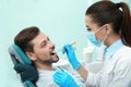 Professional dentist working with patient