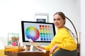 Professional designer with color palettes at workplace