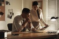 Professional detectives working at desk in office