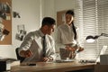 Professional detectives working at desk in office