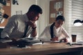 Professional detectives working at desk in office