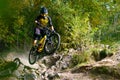 Professional Cyclist Riding the Mountain Bike on Autumn Forest Trail. Extreme Sport and Enduro Cycling Concept. Royalty Free Stock Photo