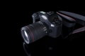 Professional digital camera with a zoom lens and a leather strap on a black background with copy space. View from above Royalty Free Stock Photo