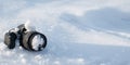 professional digital slr photo camera with frost lens lies in a snowdrift in winter in snow with copy space Royalty Free Stock Photo