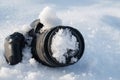 professional digital slr photo camera lies in a snowdrift in snow in winter Royalty Free Stock Photo