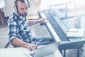 Professional disabled musician playing musical keyboard in the studio