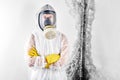 A professional disinfector in overalls processes the walls from mold. Removal of black fungus in the apartment and house. Aspergil